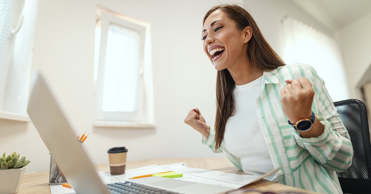young-smiling-businesswoman-is-working-computer-office-she-is-looking-something-laptop-celebrating-success